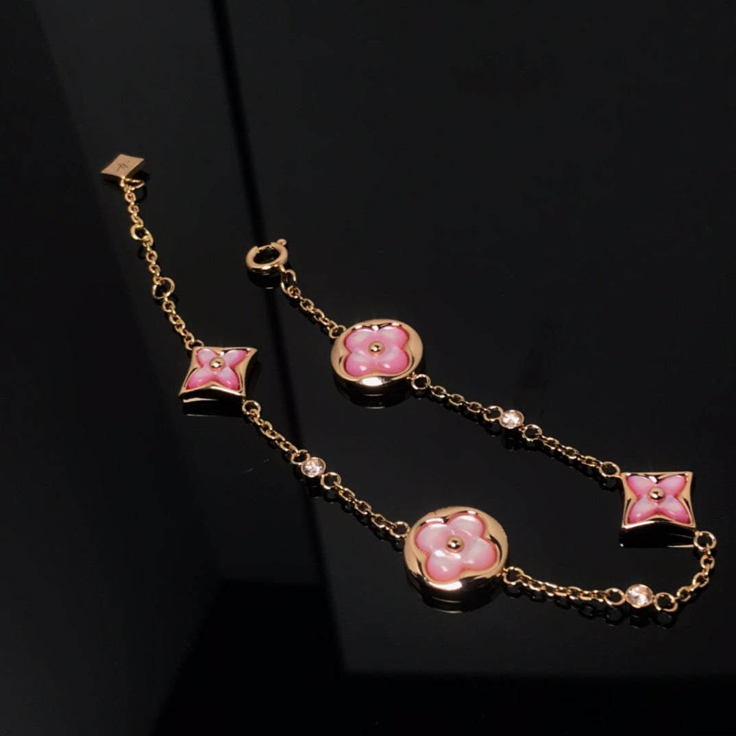 Aura STAR AND SUN 4 MOTIF PINK MOP PINK GOLD BRACELET