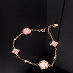 Aura STAR AND SUN 4 MOTIF PINK MOP PINK GOLD BRACELET