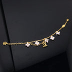 Aura LOGO 6 MOTIF STAR AND SUN GOLD BRACELET