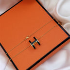 Aura HM CLIC BLACK ENAMEL GOLD NECKLACE